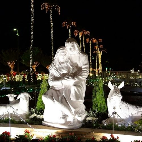 A set of white stone statues depicting the nativity with Mary, Joseph, and nearby barn animals as seen outside on the Oakland Temple grounds.